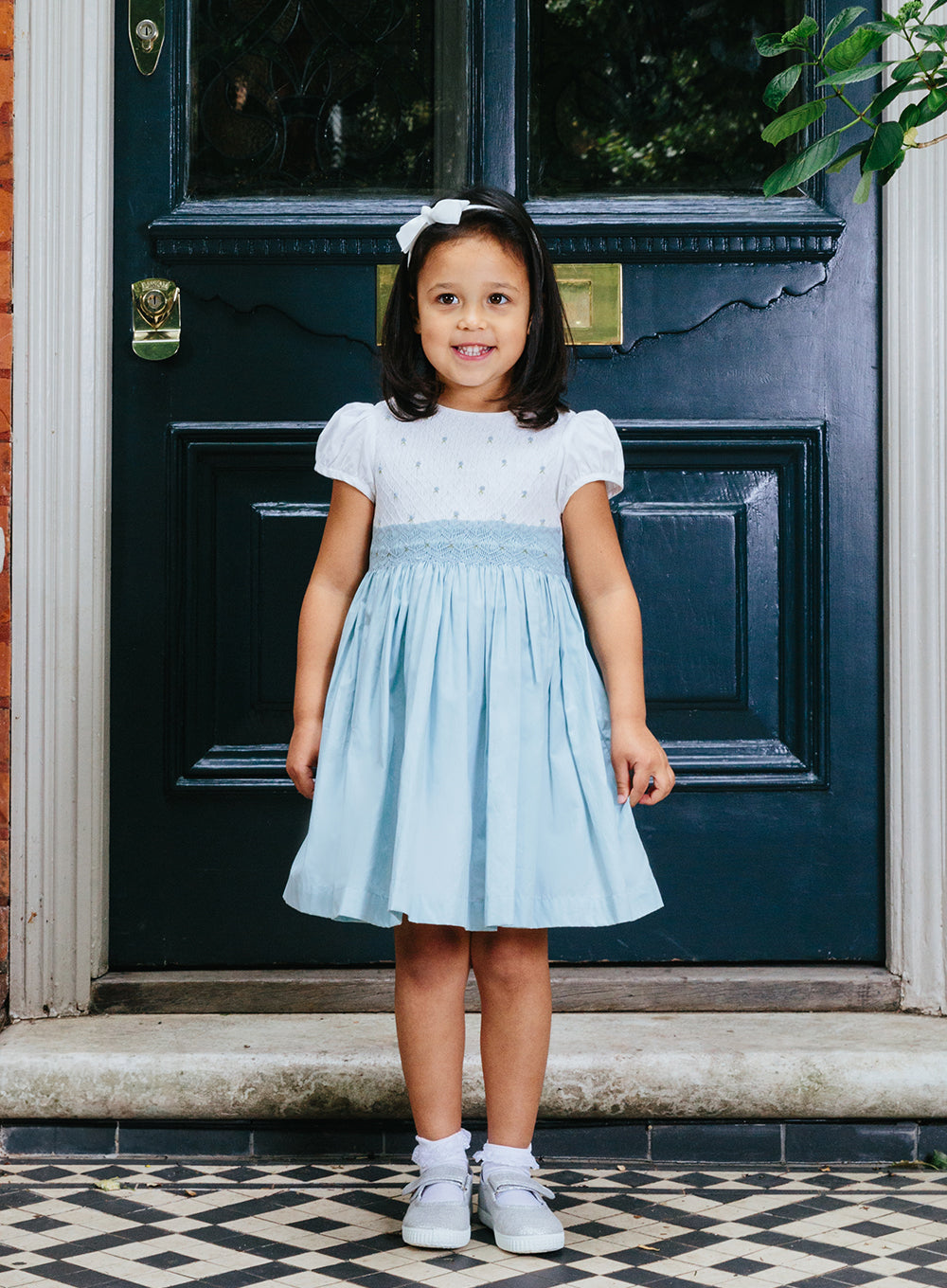 Girls Rose Hand Smocked Dress in Blue | Trotters Trotters Childrenswear USA Girls Rose Hand Smocked Dress in Blue | Trotters Trotters Childrenswear USA